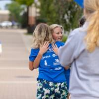 Individuals hugging at finish line